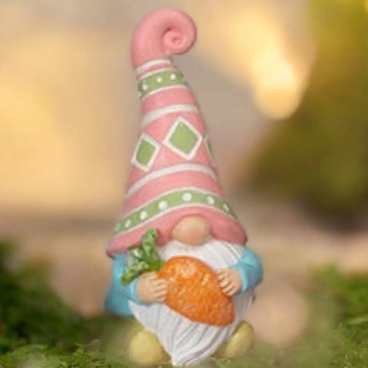 Easter gnome figurine carrying a carrot, pink hat with green diamonds, blue outfit on Tampa Home & Garden Store