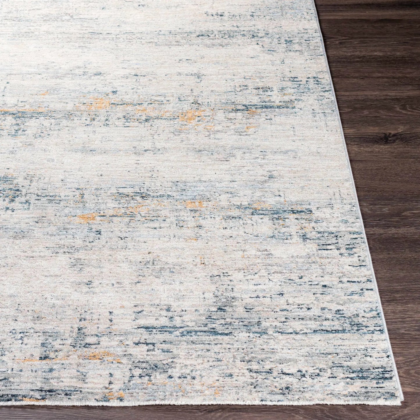 Rendlesham Luxe Rug in cream and teal, abstract pattern with fringe edge on dark wood floor on Tampa Home & Garden Store