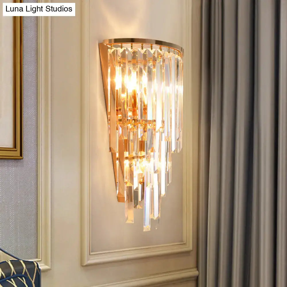 Gold crystal waterfall sconce by Decorbites; gold frame with hanging prisms, lit on Tampa Home & Garden Store