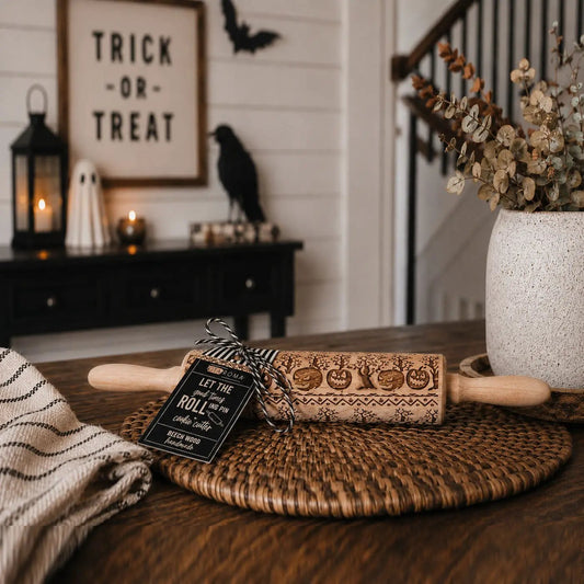 Halloween rolling pin Gia Roma with carved pumpkin motif in natural wood on woven placemat on Tampa Home & Garden Store