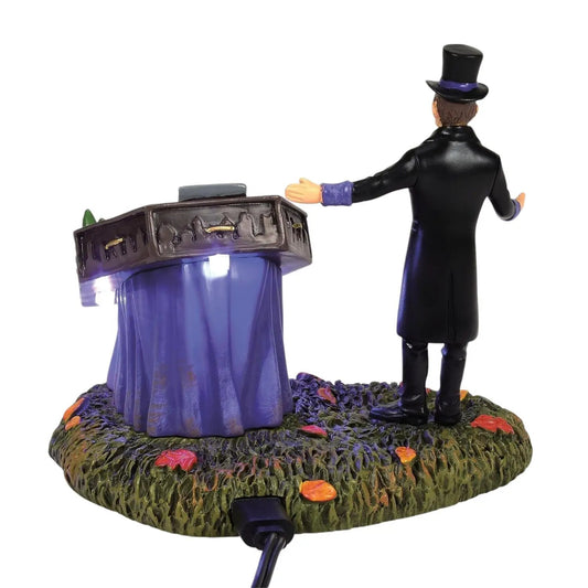 Richard Puckett Haunted Collection Lighted Figure in black coat and top hat before purple display on mossy base on Tampa Home & Garden Store