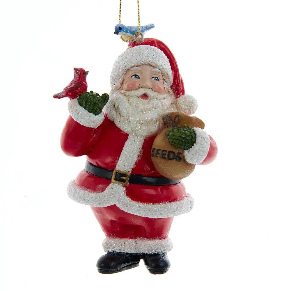 Santa Claus Christmas Ornament with two birds, red glitter suit, holding seed bag on Tampa Home & Garden Store