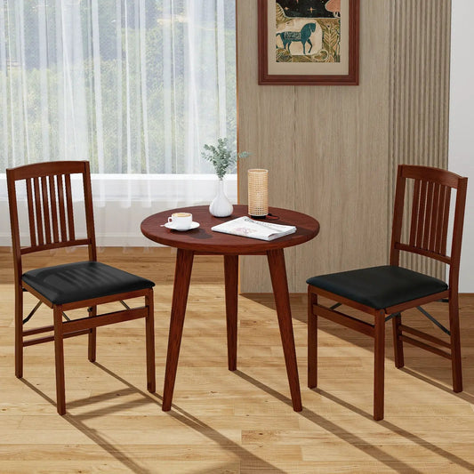 Set of 2 foldable upholstered brown dining chairs with black seats around a wood table on Tampa Home & Garden Store