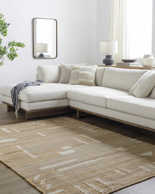 Sasha Jute Rug Hand Woven Boho Tan Cream by Boutique Rugs in a living room with beige sofa on Tampa Home & Garden Store