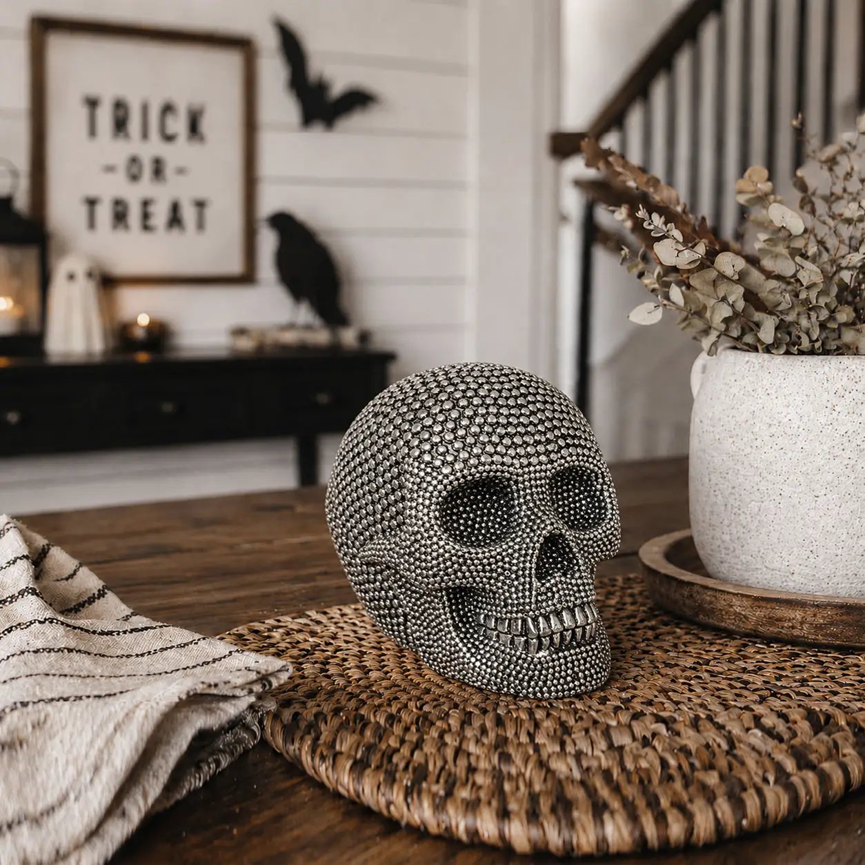 Resin beaded skull gold home decor accent on a woven round placemat on Tampa Home & Garden Store