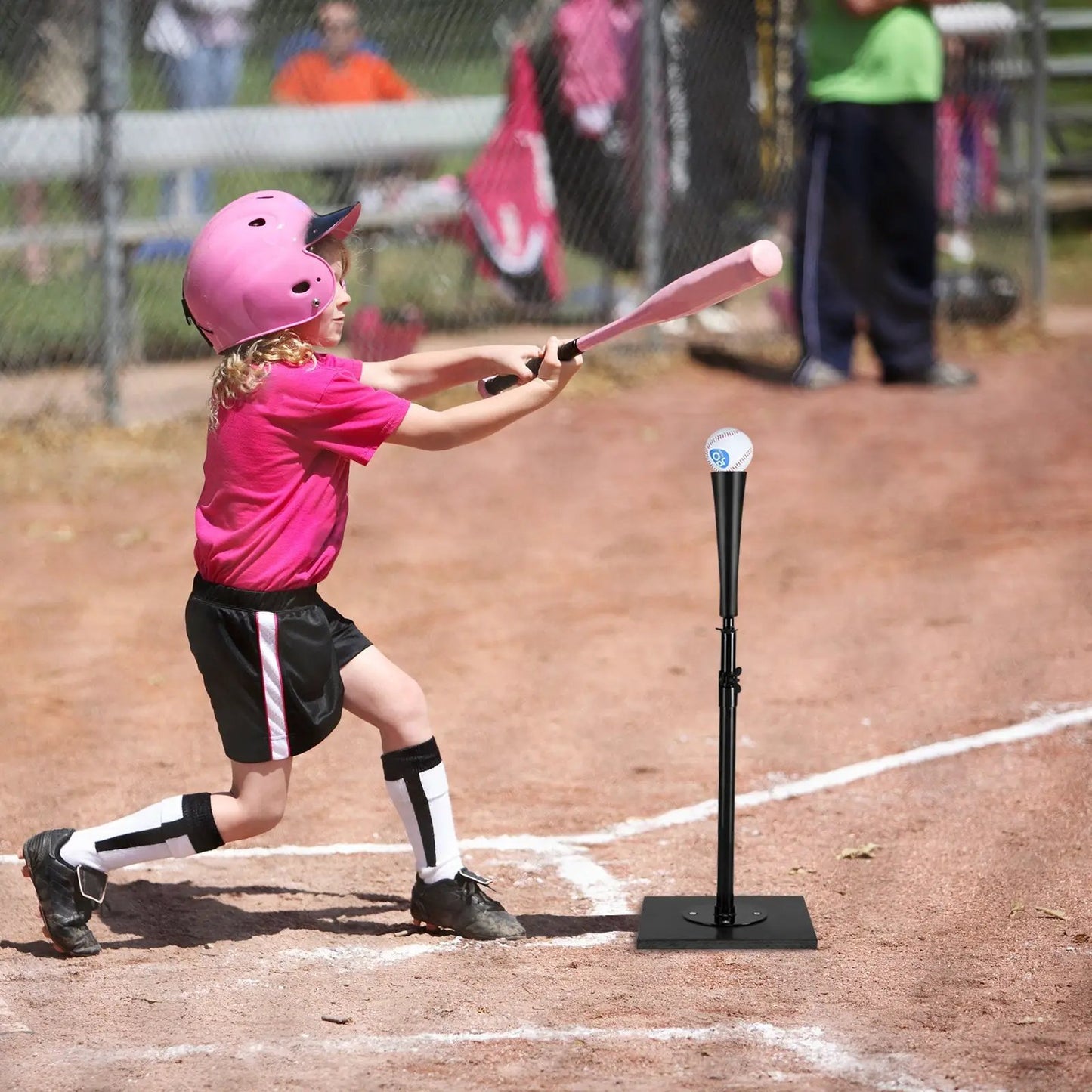36 Inch Adjustable Batting Tee with black base, baseball perched on top, girl swinging pink bat on Tampa Home & Garden Store
