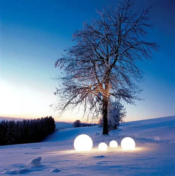 Globe Outdoor Garden Light 16 Color LED; glowing globe lamps in snowy yard by a tree at dusk on Tampa Home & Garden Store