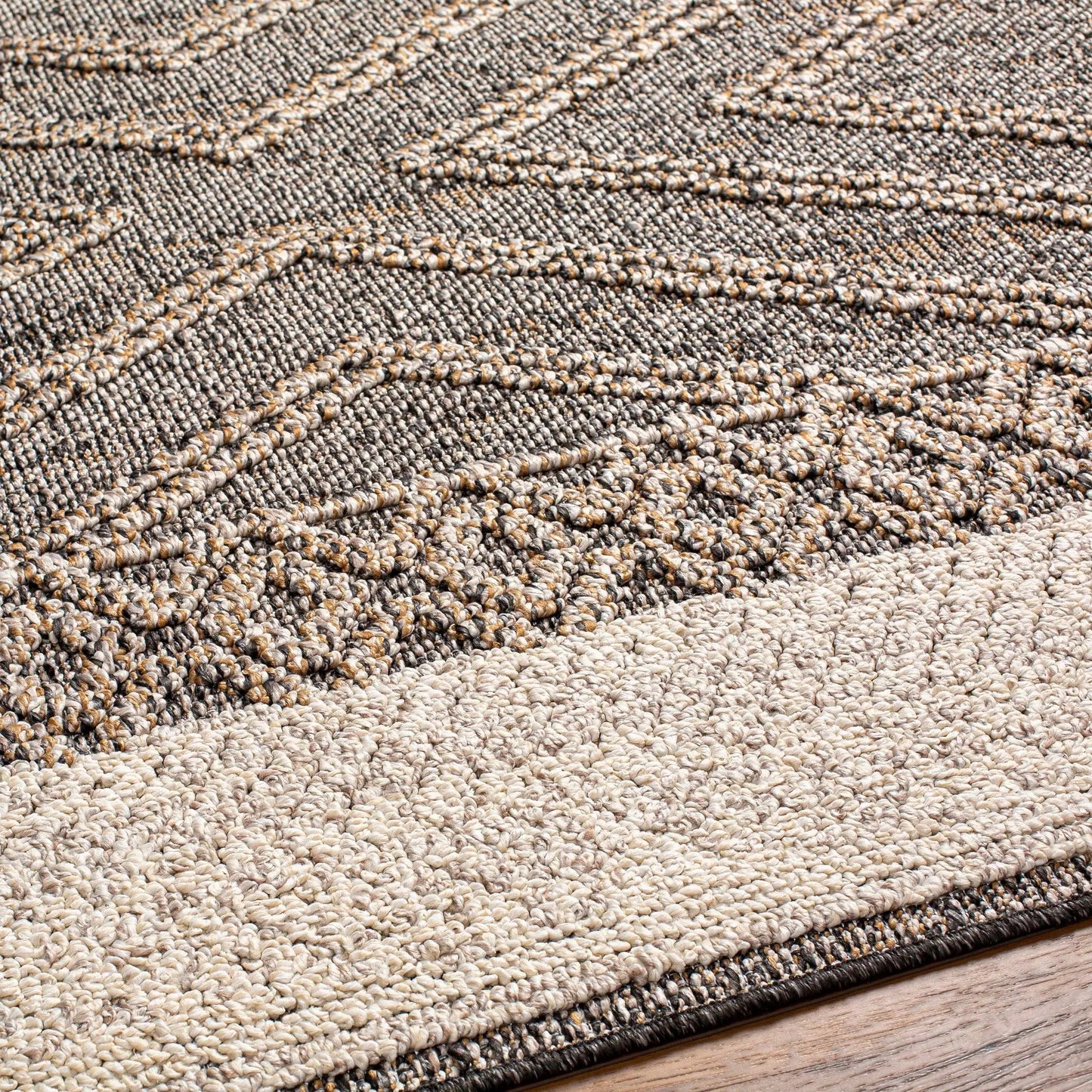Beige charcoal Areli outdoor rug closeup, textured braided weave in neutral tones on Tampa Home & Garden Store