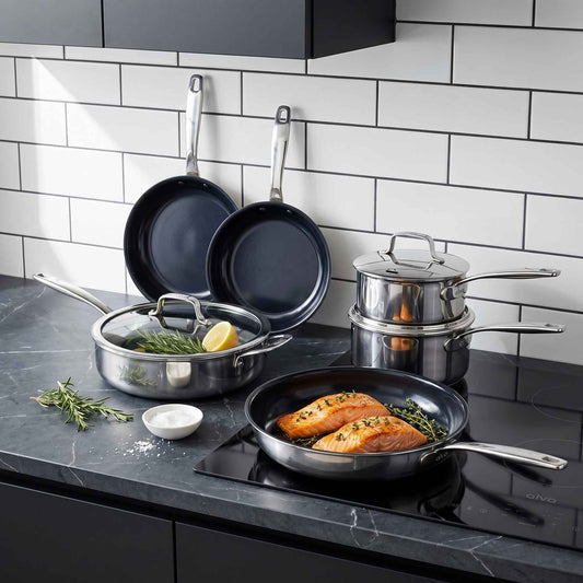 Alva Hybrid Cookware Set, 7-Piece mixed-metal pots and pans with glass lids on a dark countertop on Tampa Home & Garden Store