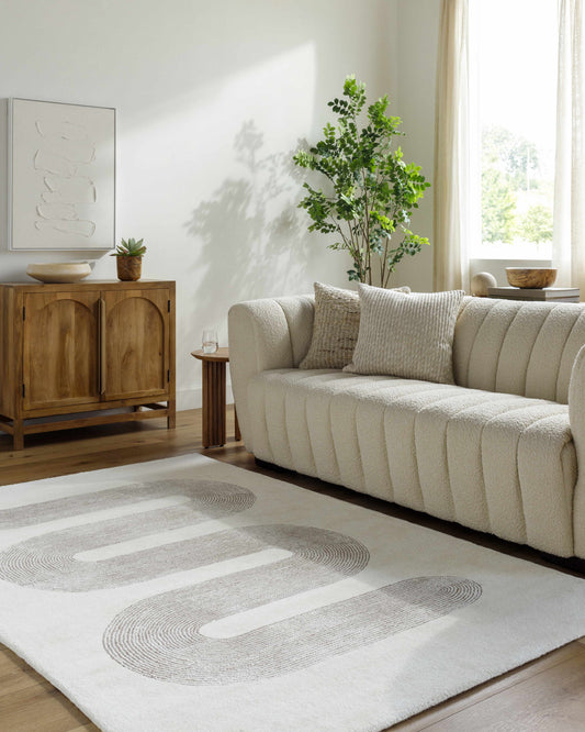 Saura Area Rug by Boutique Rugs, cream textured rug with circular gray swirl pattern on Tampa Home & Garden Store