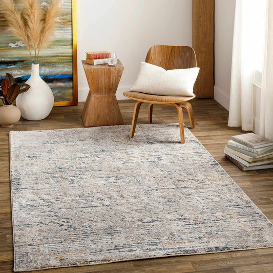 Sywell Luxe Fringe Rug in Charcoal Beige by Boutique Rugs with blue-gray flecks in living room on Tampa Home & Garden Store