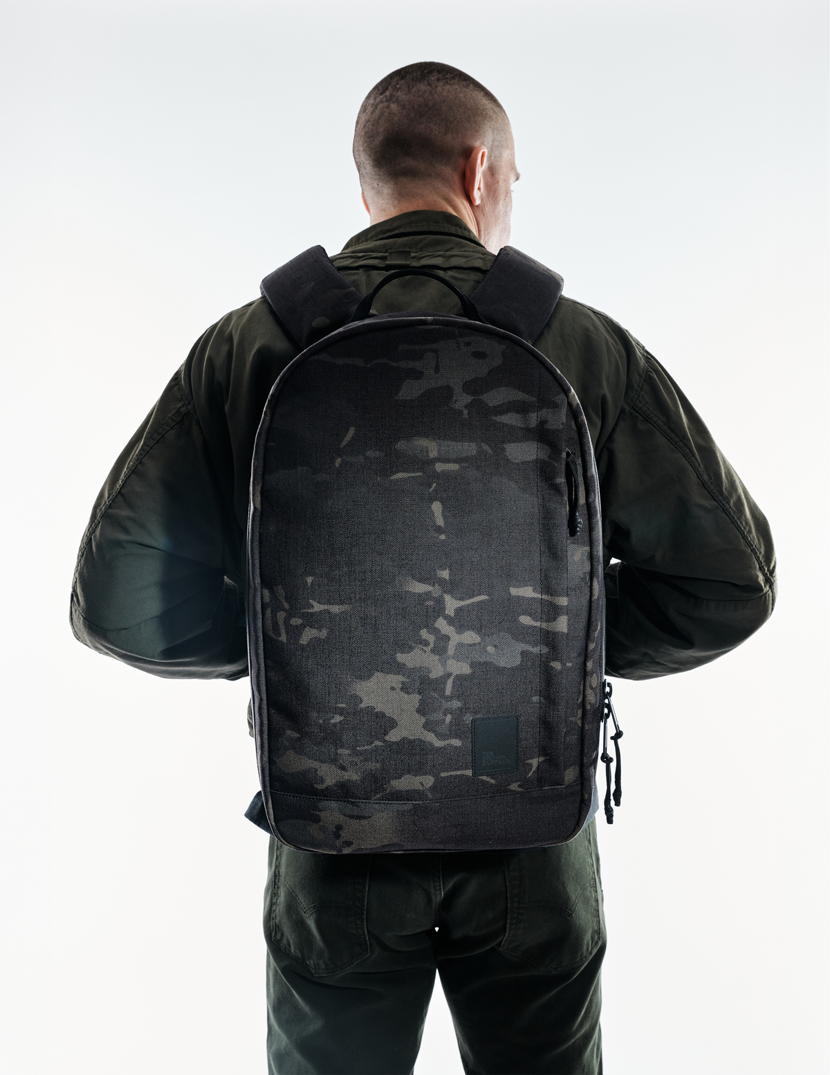 The Brown Buffalo Conceal Pack 21L camouflage backpack worn by a person from the back on Tampa Home & Garden Store