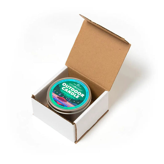 Outdoor candle tin by City Bonfires in eucalyptus scent with teal label in a white cardboard box on Tampa Home & Garden Store