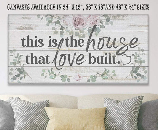 Canvas wall hanging This Is the House That Love Built with rustic wood planks and floral accents on Tampa Home & Garden Store