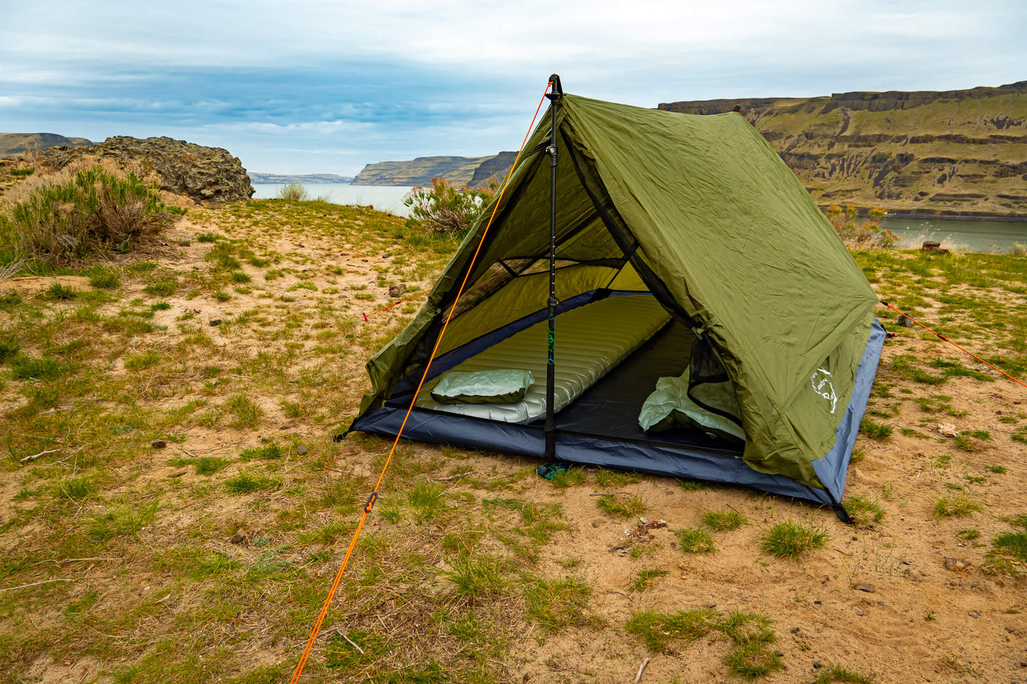 Trekker Tent 2.2 2-Person Backpacking Tent in olive green with sleeping pads and orange guylines on Tampa Home & Garden Store