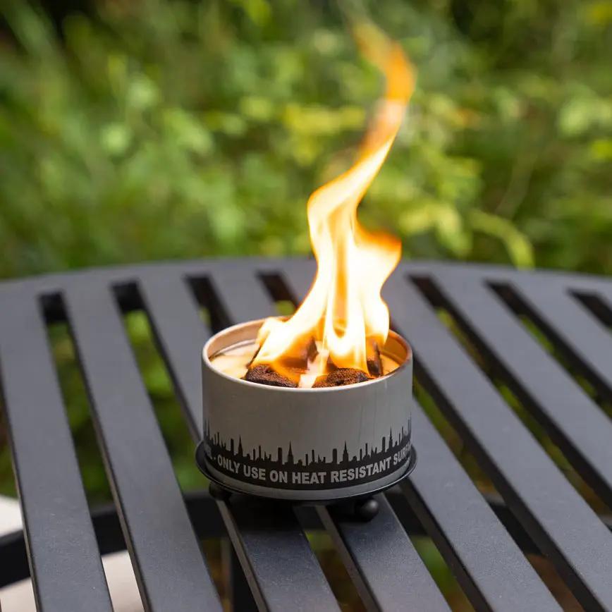 Gray metal trivet and candle holder for outdoor fire pits with a skyline band and flame on Tampa Home & Garden Store