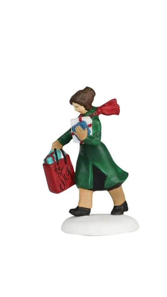 Busy City Sidewalks Village Accessory Set shopper figure in green coat with red scarf carrying red shopping bag and blue book on snow on Tampa Home & Garden Store