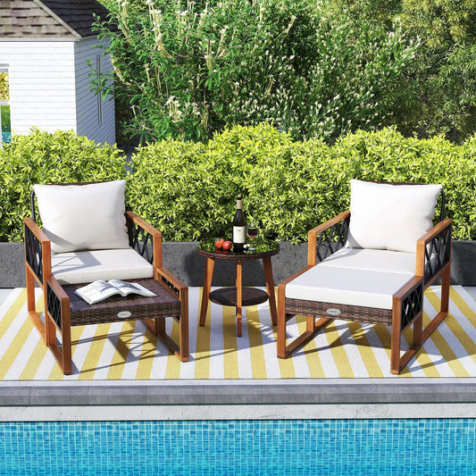 Outdoor 5-Piece rattan and acacia patio set; 2 chairs with white cushions and table on rug on Tampa Home & Garden Store