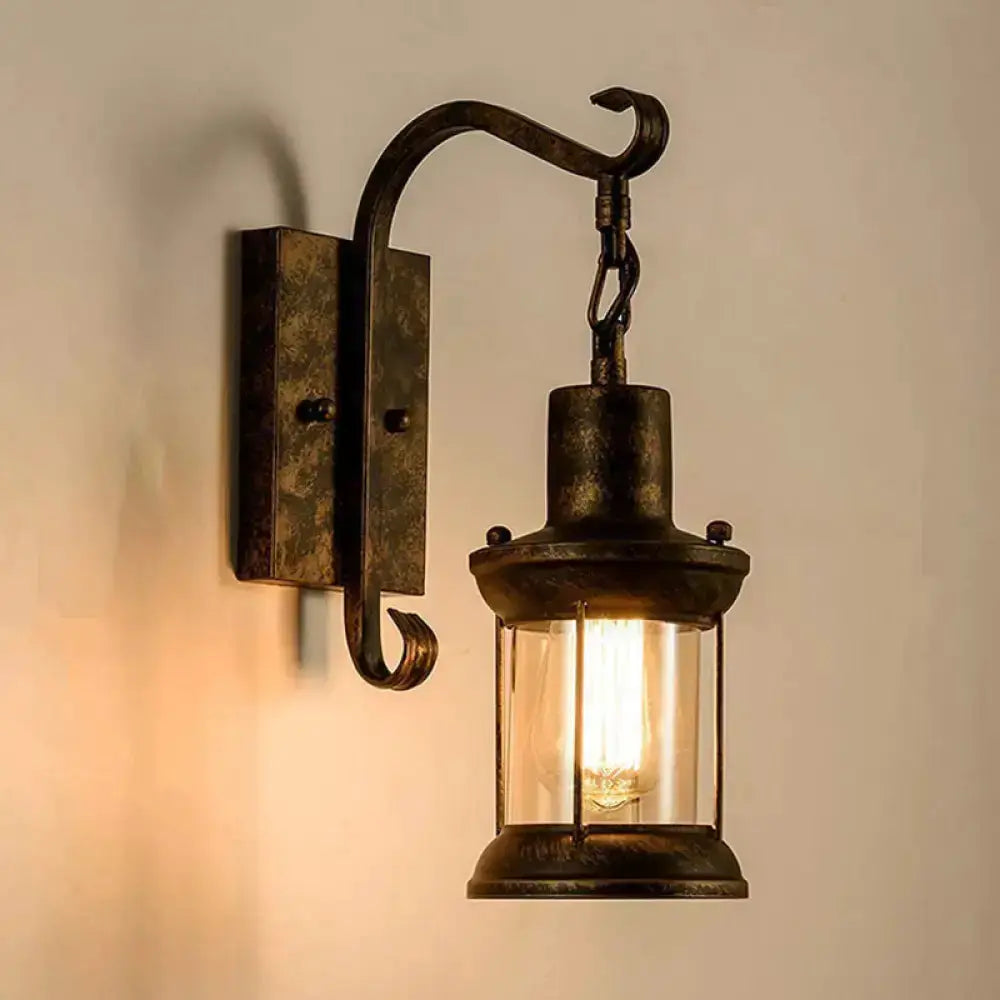 Vintage black lantern wall sconce with curved arm, glass enclosure for dining room lighting on Tampa Home & Garden Store