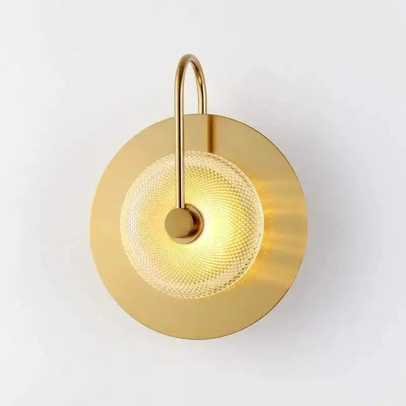 Vintage brass wall light with curved arm and textured glass diffuser on round backplate on Tampa Home & Garden Store