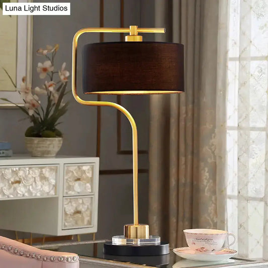 Vintage black table lamp with brass curved stem and black drum shade, single bulb on Tampa Home & Garden Store