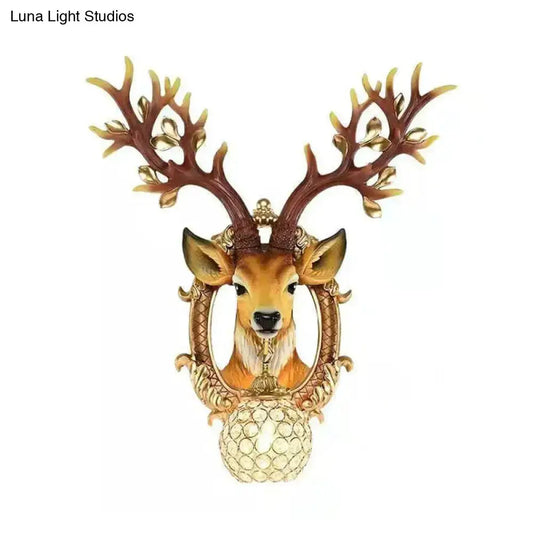 Vintage brown globe wall light with a metal deer backplate and ornate antler frame on Tampa Home & Garden Store