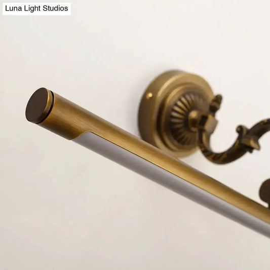 Vintage brass tubular wall sconce by Decorbites with LED vanity light and ornate backplate on Tampa Home & Garden Store