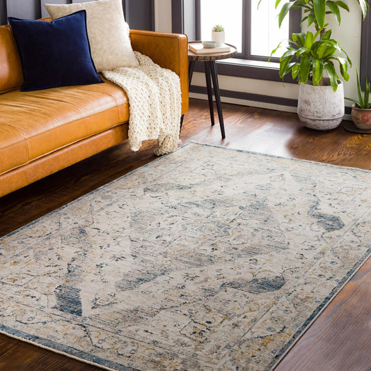 Wadeye Luxe Fringe Rug Mustard and Gray by Boutique Rugs in a living room on tan leather sofa on Tampa Home & Garden Store