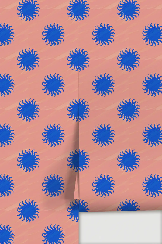 Sol Wallpaper by Samantha Santana Creative: pink backdrop with blue sunbursts; folded edge on Tampa Home & Garden Store