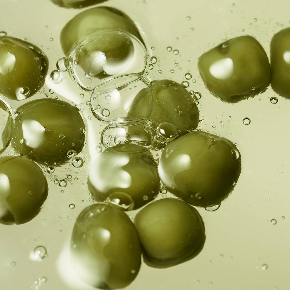 Whamisa Organic Seeds Green Peas Shampoo close-up: green pea seeds in bubbly liquid on Tampa Home & Garden Store