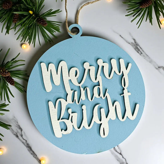 Merry and Bright wooden ornament for the tree in light blue with white raised script on a round disc on Tampa Home & Garden Store