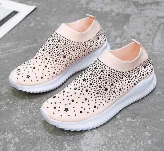 White Stevvex crystal slip-on sneakers pair with black studs on Tampa Home & Garden Store
