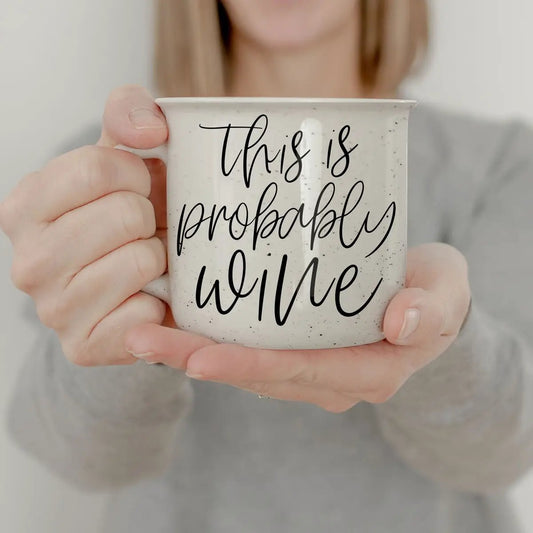 Coffee mug Gia Roma speckled white ceramic with this is probably wine script held by hands on Tampa Home & Garden Store