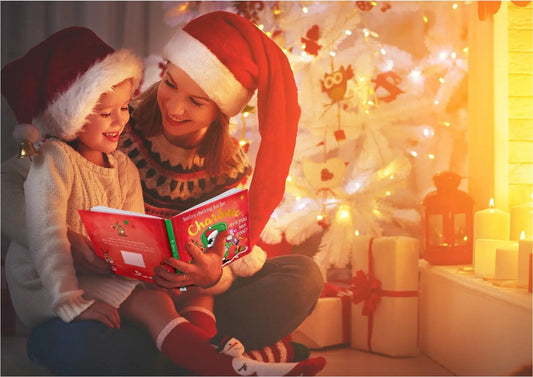 Personalized Christmas Storybook Hardcover red cover read by mom and child beside a tree on Tampa Home & Garden Store