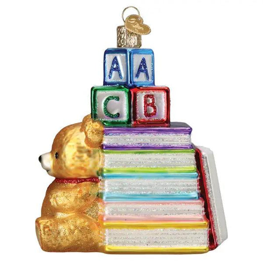 Favorite Children's Books Glass Ornament with a golden teddy bear and colorful book stack on Tampa Home & Garden Store