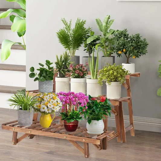 Three-tier wooden ladder plant stand in natural wood with assorted potted plants for indoor use on Tampa Home & Garden Store