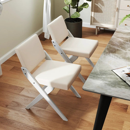 Two white padded dining chairs with rubber wood frames, folding design by DirectDeals on Tampa Home & Garden Store
