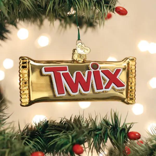 Twix glass ornament gold foil with red TWIX logo hanging on Christmas tree branch on Tampa Home & Garden Store