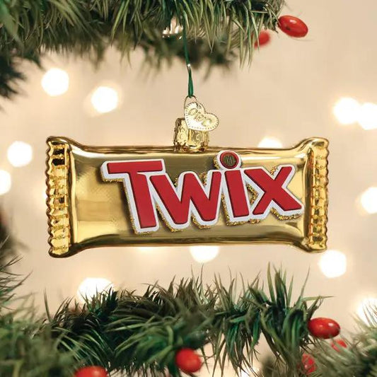 Twix glass ornament gold foil with red TWIX logo hanging on Christmas tree branch on Tampa Home & Garden Store