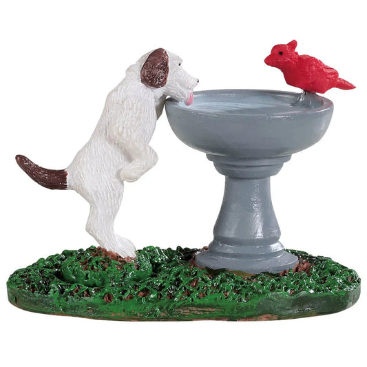 Playful dog birdbath ornament with gray fountain and red bird on a green base on Tampa Home & Garden Store