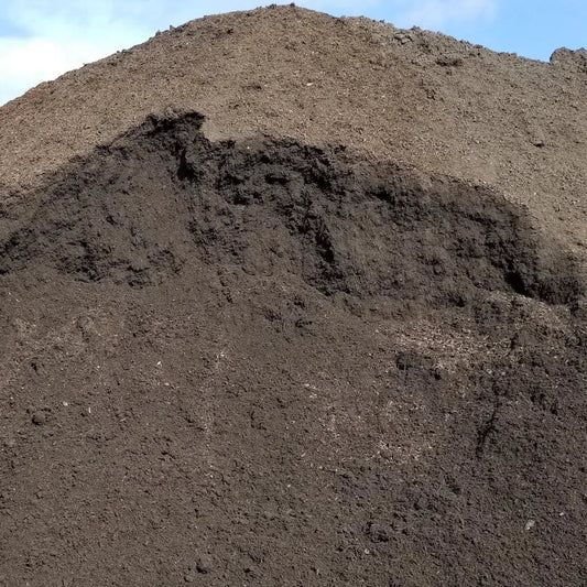 Organic garden soil 9 cu yd truckload mound, dark brown, rough texture on Tampa Home & Garden Store