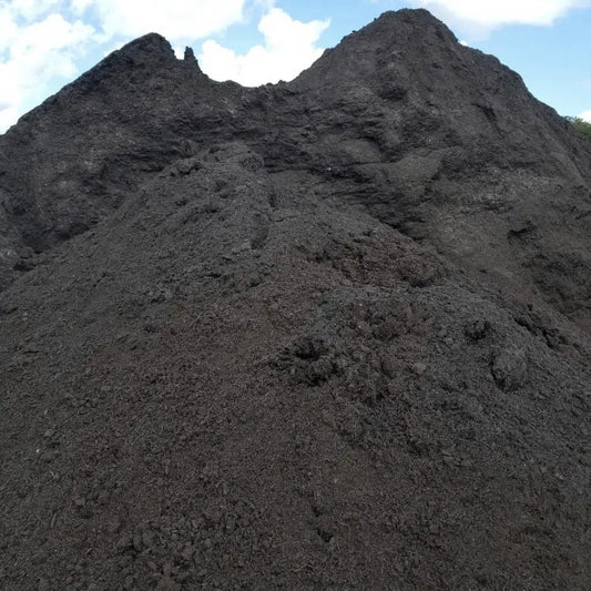 Composted manure bulk compost pile in dark black soil amendment for Tampa delivery on Tampa Home & Garden Store
