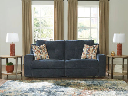 Danum - 2 Seat Reclining Sofa in blue textured fabric with geometric pillows on Tampa Home & Garden Store