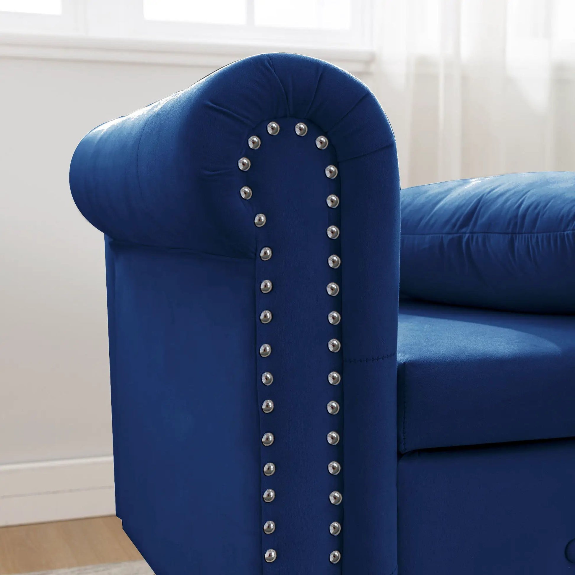 Blue upholstered chaise lounge with nailhead trim and curved rolled arm on Tampa Home & Garden Store