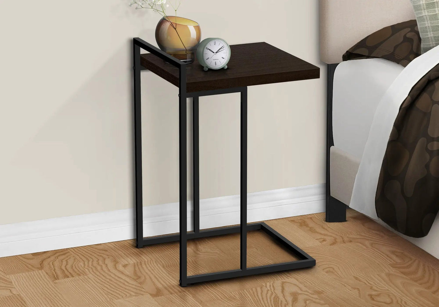 C-shaped accent table with dark wood top and black metal frame, amber vase and teal clock on Tampa Home & Garden Store
