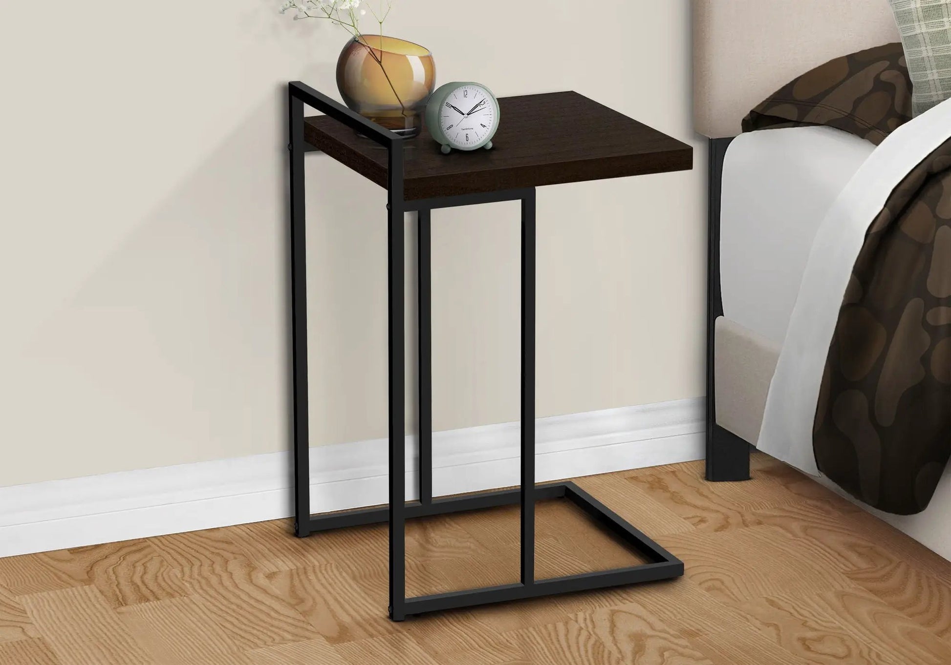 C-shaped accent table with dark wood top and black metal frame, amber vase and teal clock on Tampa Home & Garden Store