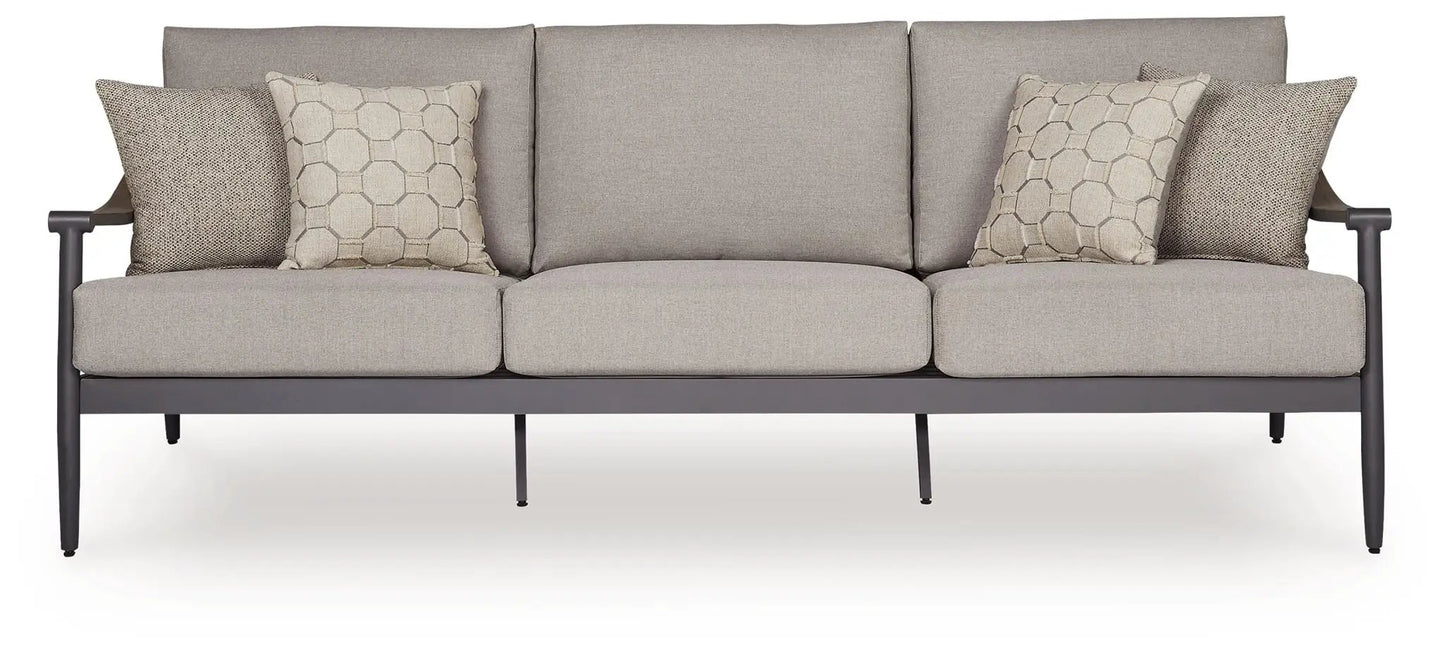 Ocean Beach outdoor sofa with gray cushions and four beige pillows on dark metal frame on Tampa Home & Garden Store