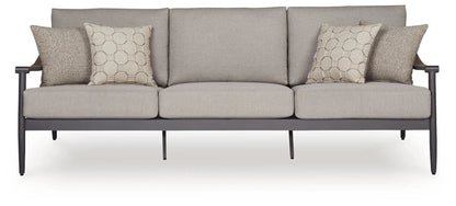 Ocean Beach outdoor sofa with gray cushions and four beige pillows on dark metal frame on Tampa Home & Garden Store