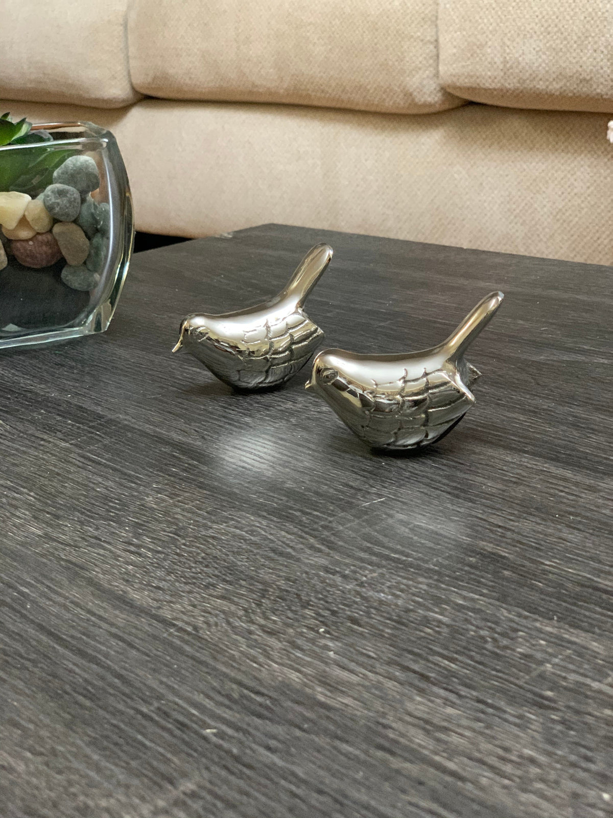 Vibhsa silver bird figurines set of 2 on dark wood surface beside a glass vase with stones on Tampa Home & Garden Store