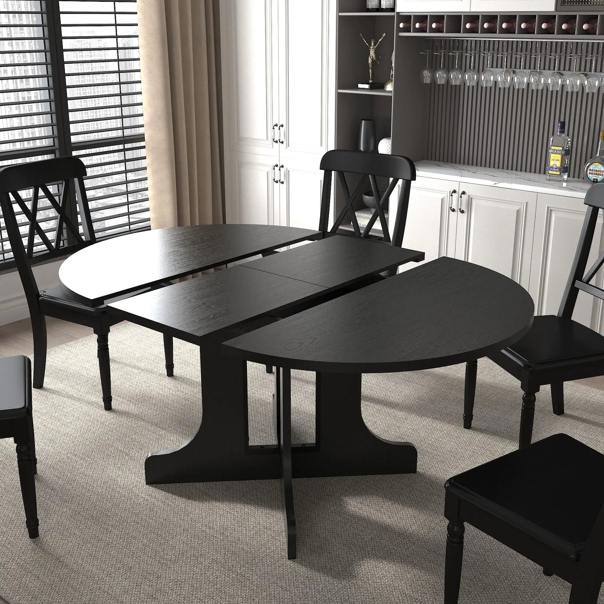 Black oval expandable dining table with removable leaf and X-shaped trestle base on Tampa Home & Garden Store
